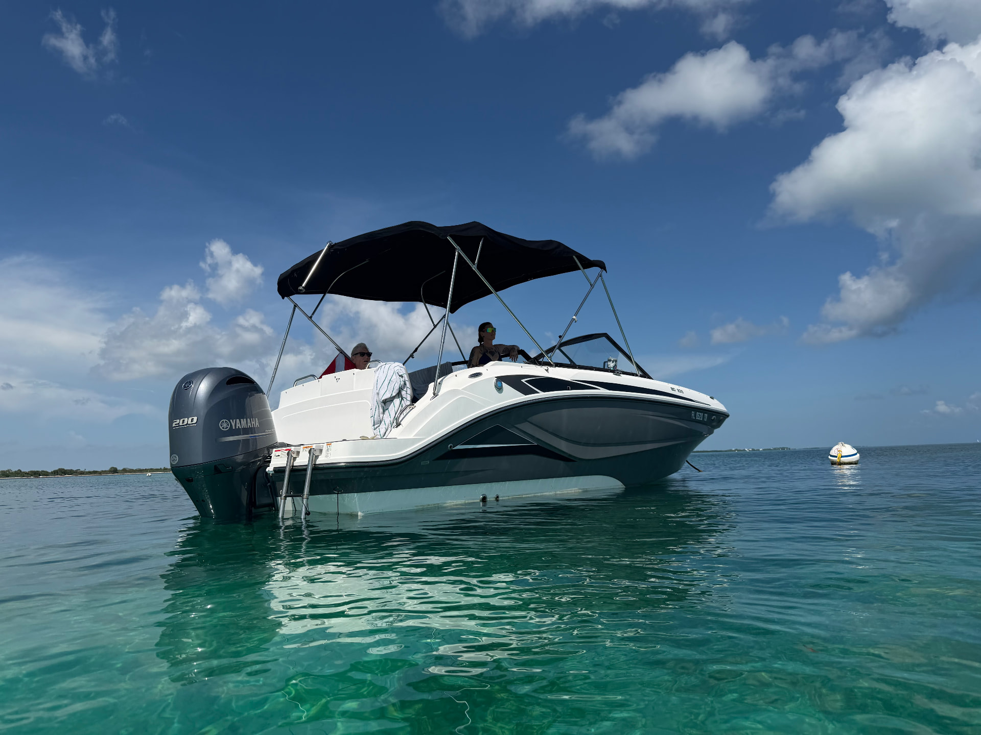 Private charter boat anchored in shallow turquoise water at a Big Pine Key sandbar